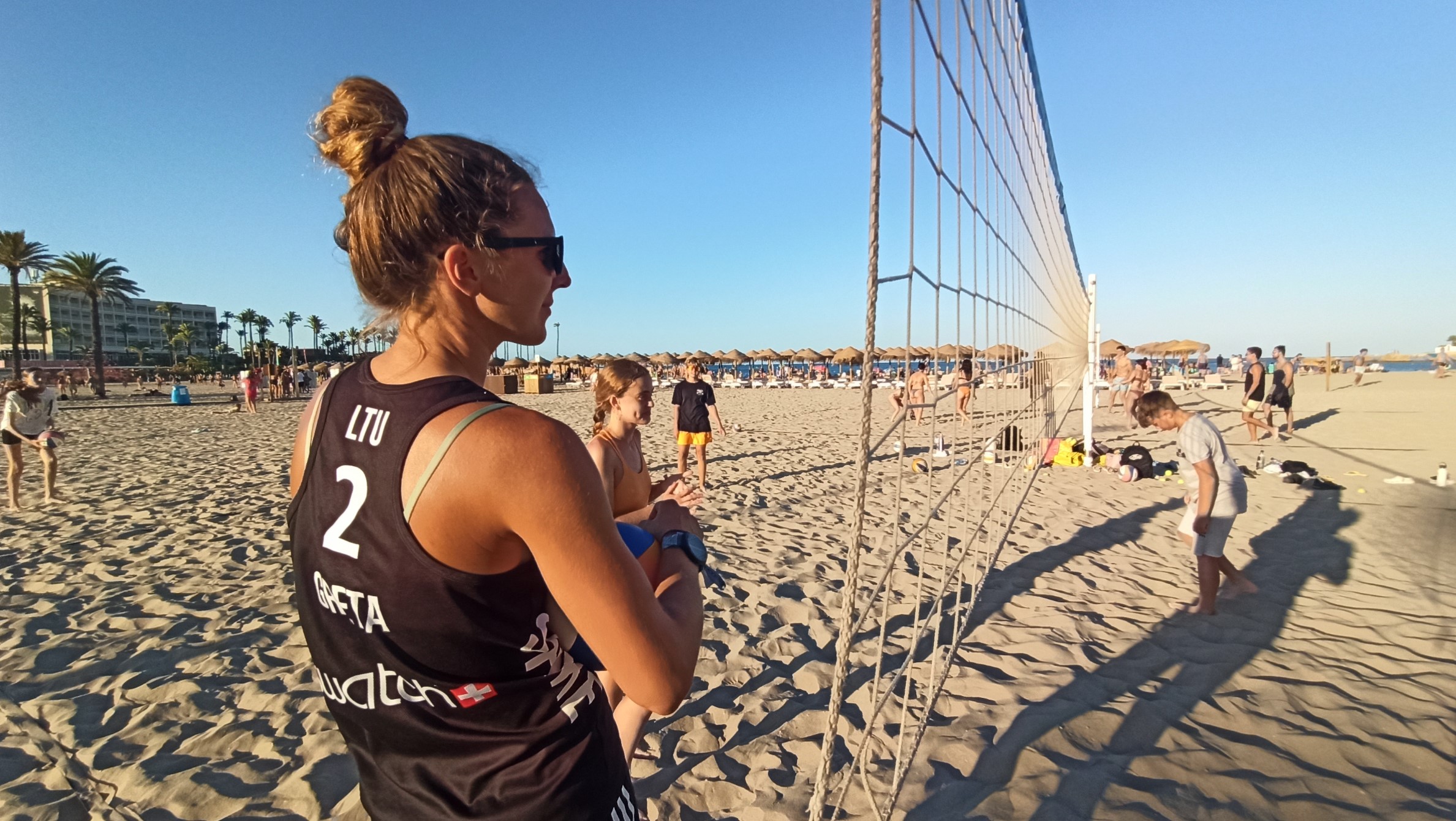 Beach volleybal coach seeing training from the net